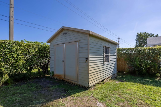 view of outbuilding with a lawn