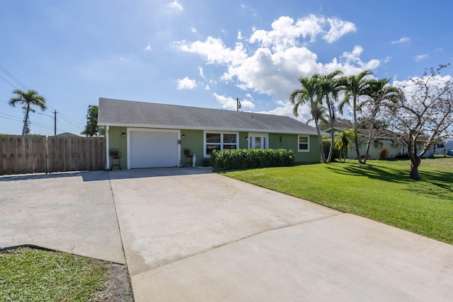 ranch-style house featuring a garage and a front yard