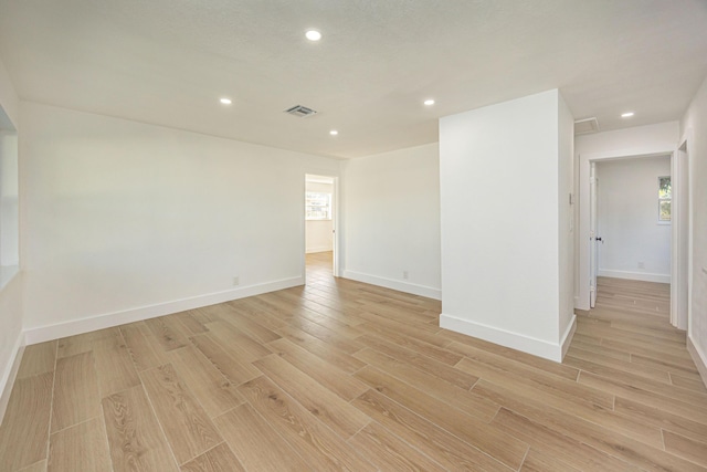 unfurnished room with light wood-type flooring