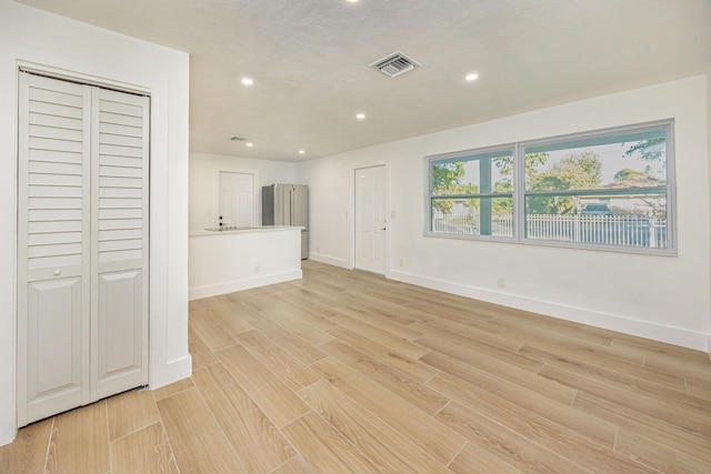 unfurnished living room featuring light hardwood / wood-style flooring