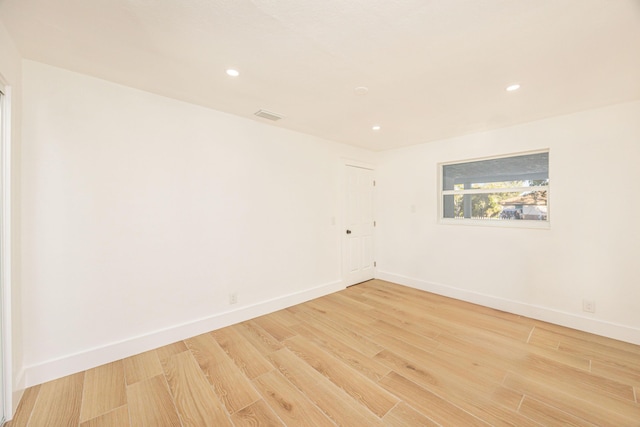 spare room featuring light hardwood / wood-style flooring