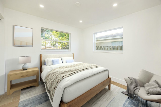 bedroom featuring multiple windows and hardwood / wood-style flooring