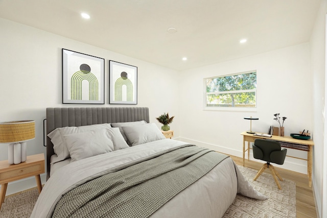 bedroom featuring radiator heating unit and light wood-type flooring