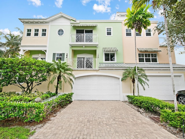 view of front of property with a garage and a balcony