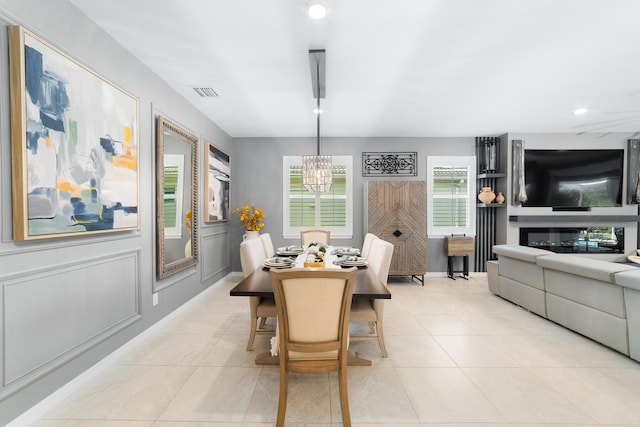 dining space with light tile patterned flooring, visible vents, recessed lighting, and an inviting chandelier