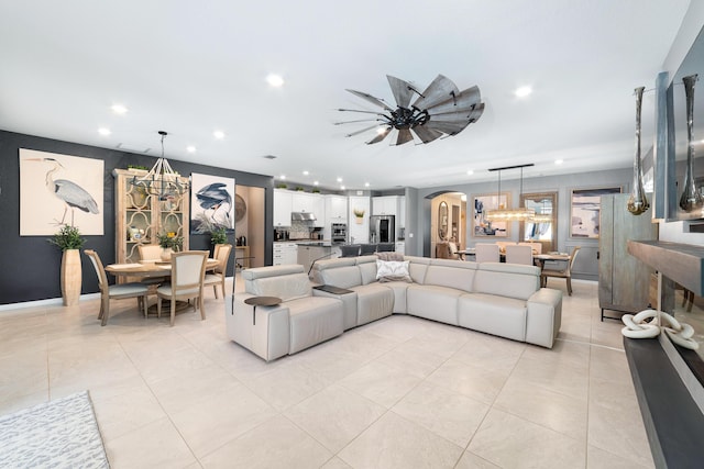 living area with recessed lighting, arched walkways, and light tile patterned flooring