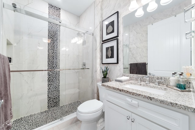 bathroom featuring vanity, toilet, and a marble finish shower