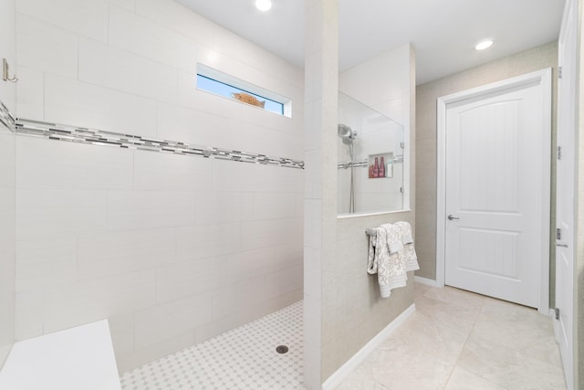 full bath with tile patterned floors, a walk in shower, and baseboards