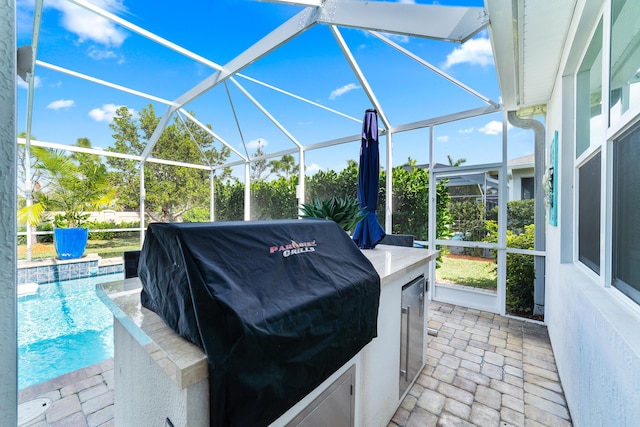 view of patio / terrace with an outdoor pool, grilling area, and a lanai