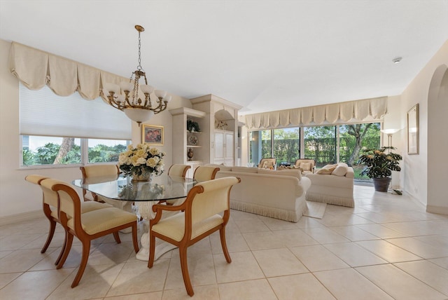 tiled dining area with a notable chandelier and a wealth of natural light