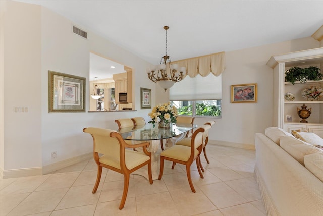 tiled dining area with a chandelier