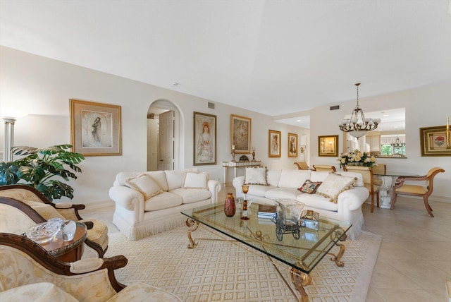 tiled living room featuring an inviting chandelier