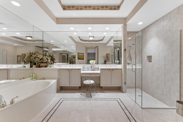 bathroom with tile patterned floors, vanity, independent shower and bath, and a raised ceiling