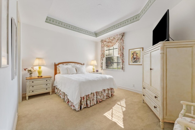 carpeted bedroom with a tray ceiling