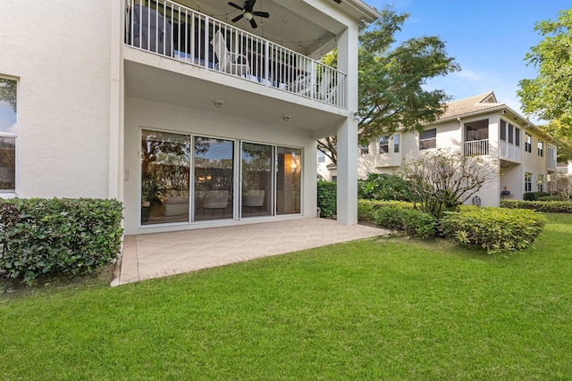 back of house featuring a patio, a yard, and ceiling fan