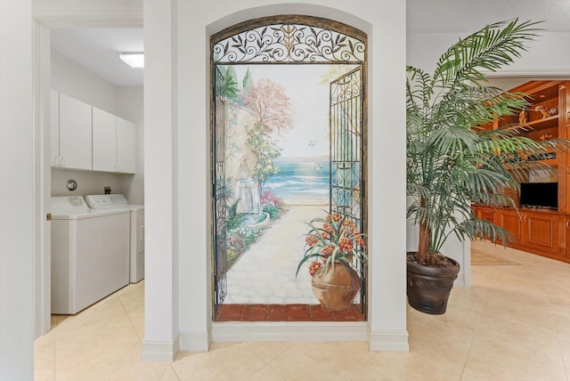 interior space with washer and clothes dryer and light tile patterned flooring