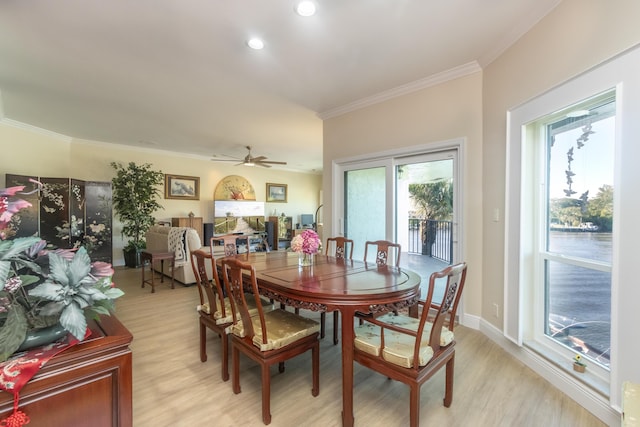 dining room featuring plenty of natural light, baseboards, light wood-style flooring, and crown molding