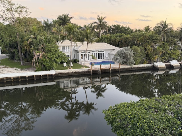 exterior space featuring a water view and an outdoor pool