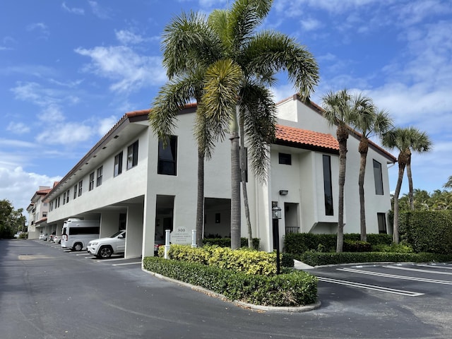 view of building exterior with uncovered parking