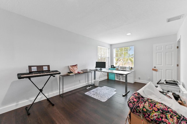 office area featuring baseboards, visible vents, dark wood-type flooring, a textured ceiling, and recessed lighting