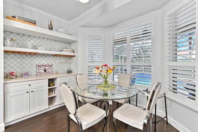 dining room featuring baseboards, dark wood-type flooring, and crown molding