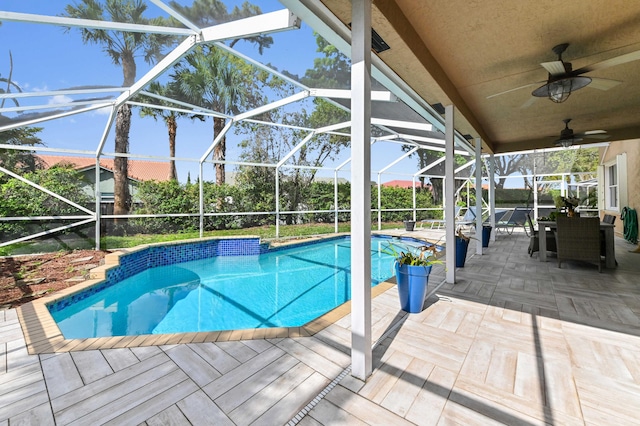 pool featuring a lanai, outdoor dining space, a ceiling fan, and a patio