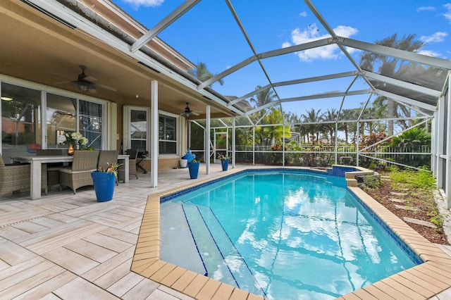 view of swimming pool with a ceiling fan, a lanai, fence, a patio area, and a pool with connected hot tub