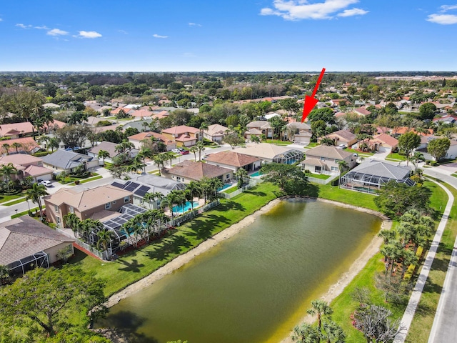 drone / aerial view with a water view and a residential view