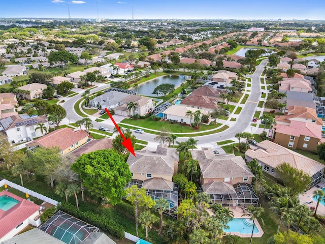 birds eye view of property with a water view and a residential view