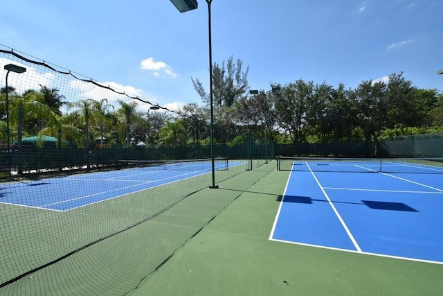 view of sport court with fence