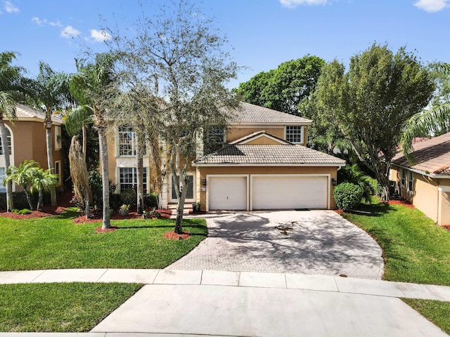 view of front of home with a garage, a tiled roof, decorative driveway, and a front yard