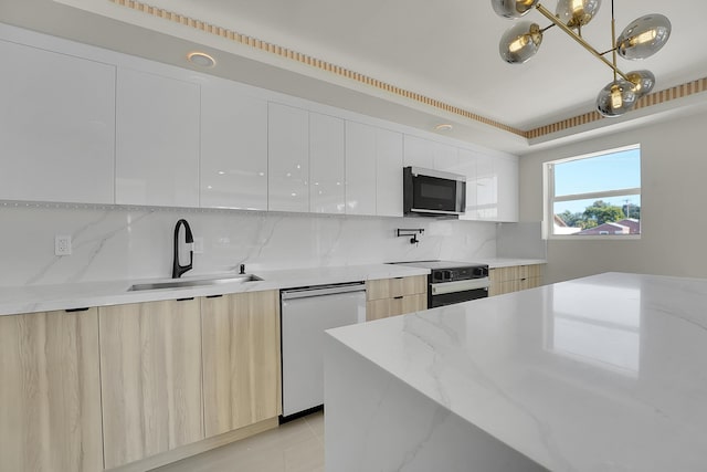 kitchen with sink, decorative light fixtures, black electric range, dishwasher, and white cabinets