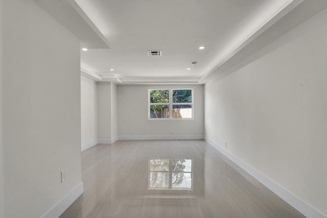 unfurnished room with a raised ceiling