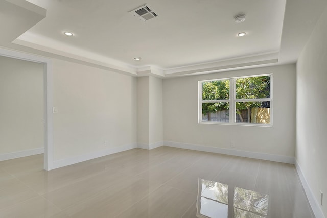 unfurnished room with a tray ceiling