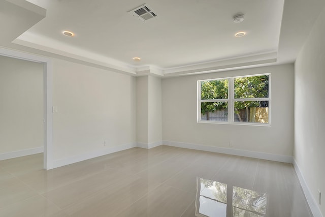 empty room featuring a tray ceiling