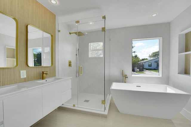 bathroom featuring vanity and separate shower and tub