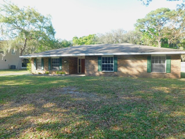 single story home with central AC and a front lawn