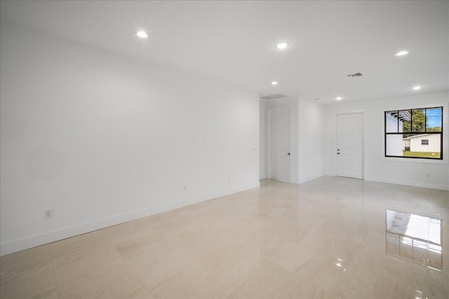 unfurnished room with recessed lighting, visible vents, and baseboards