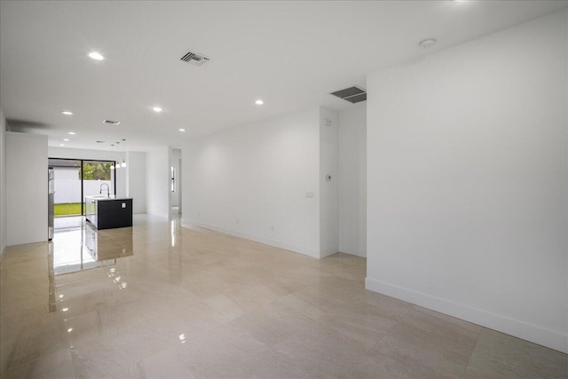 empty room with baseboards, visible vents, and recessed lighting