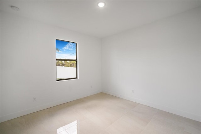 unfurnished room featuring baseboards