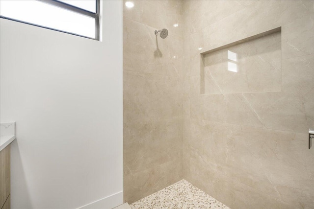 full bath with tiled shower