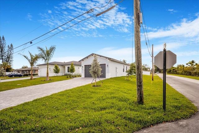 view of front of property with a front lawn, decorative driveway, and an attached garage