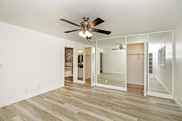 empty room featuring ceiling fan and light hardwood / wood-style flooring