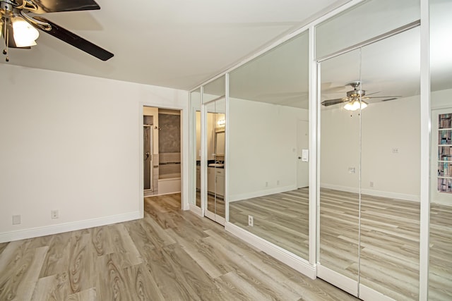 unfurnished room with ceiling fan and light wood-type flooring