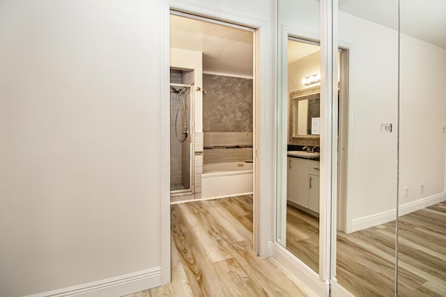 hall featuring sink and light wood-type flooring