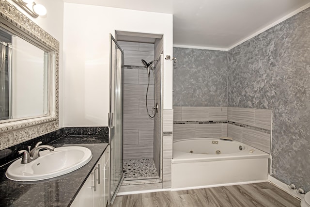 bathroom featuring wood-type flooring, independent shower and bath, and vanity