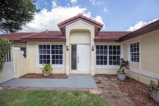 entrance to property featuring a patio area