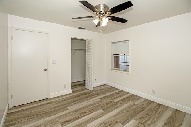 unfurnished bedroom featuring ceiling fan, light hardwood / wood-style floors, and a closet