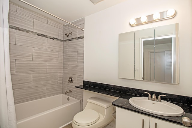 full bathroom with vanity, shower / tub combo, and toilet