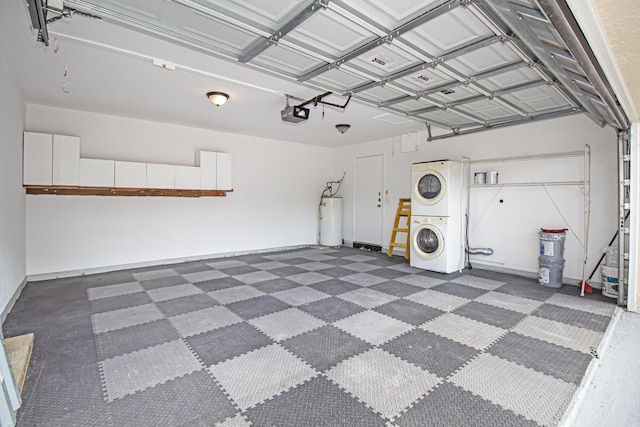 garage featuring water heater, stacked washing maching and dryer, and a garage door opener